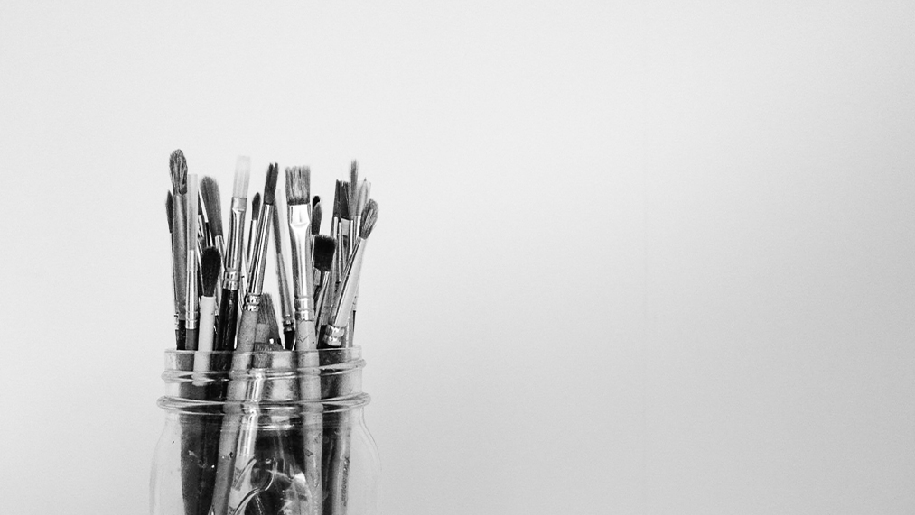 jar with paintbrushes