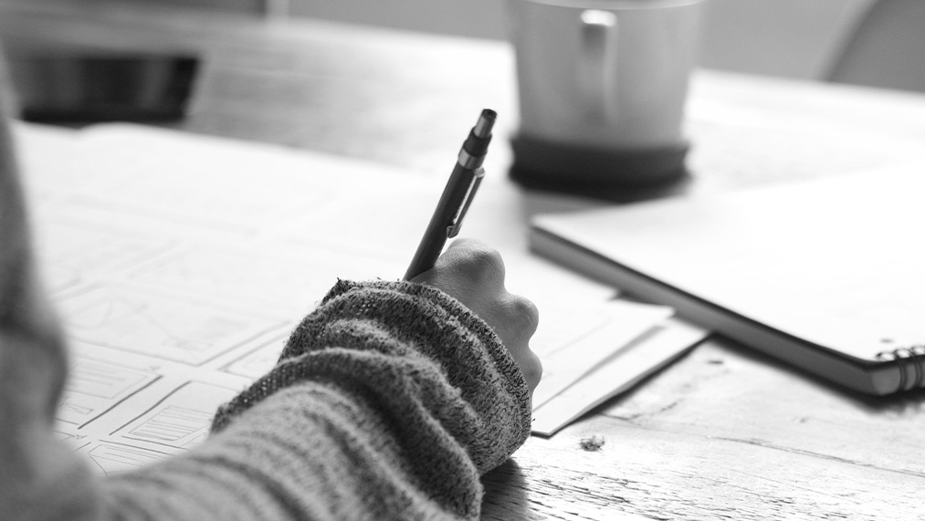 person writing with a pen