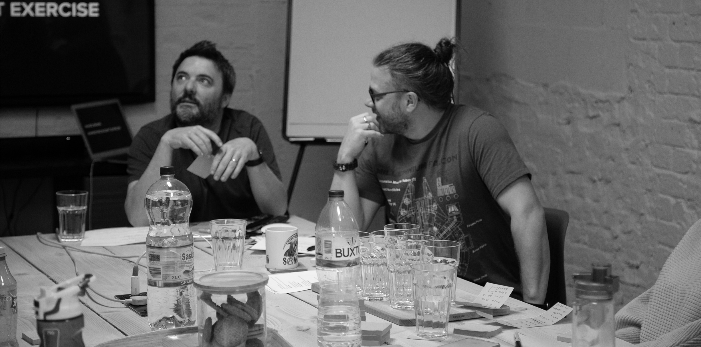Matt and Chris talking in a meeting room