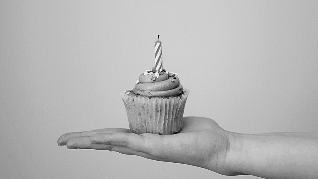 Someone holding a birthday cake