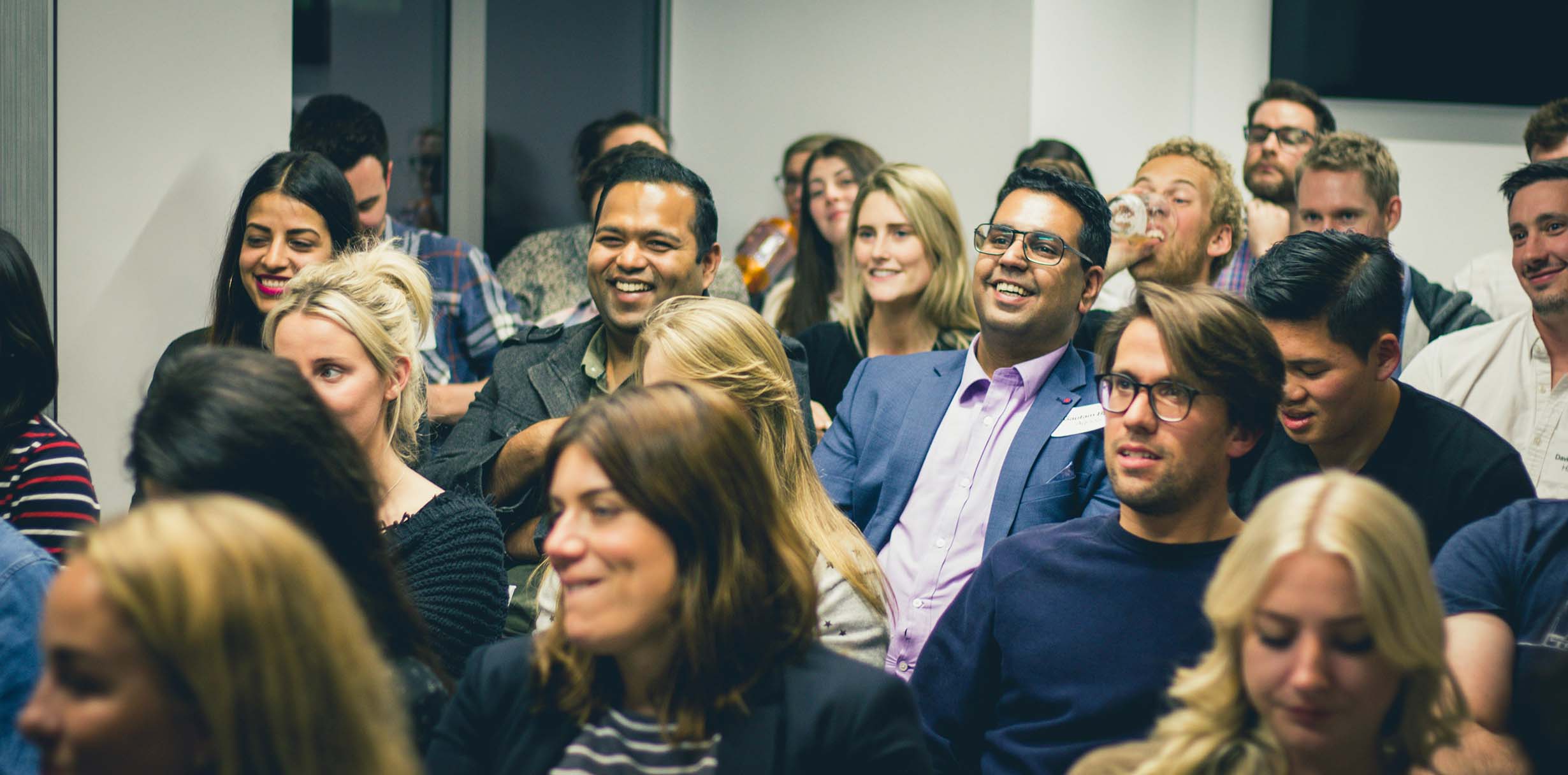 A crowd of people watching a presentation