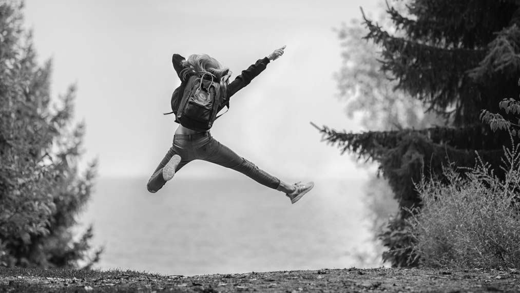 Young adult jumping with joy