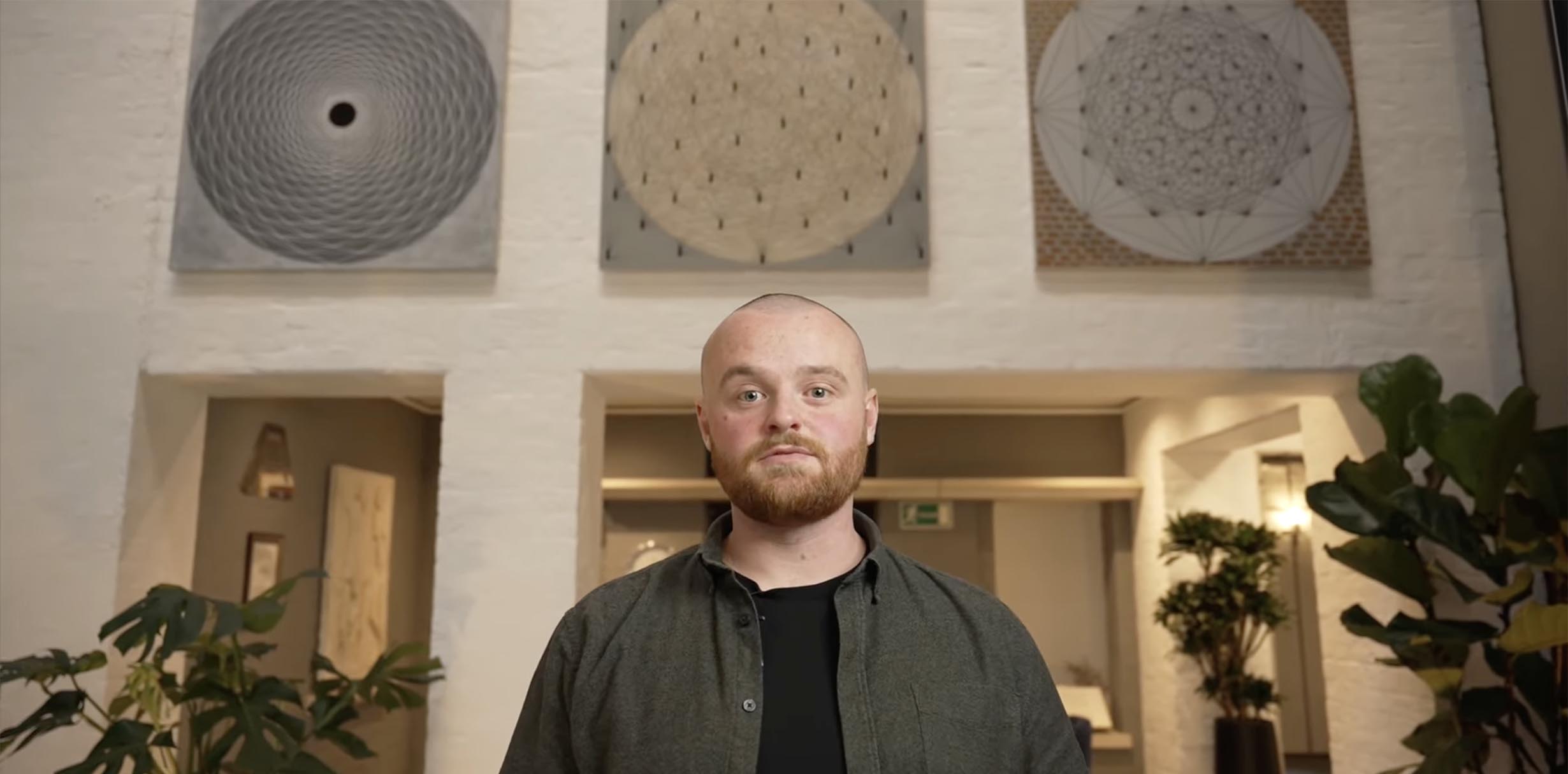 A man looking straight at the camera, in an office